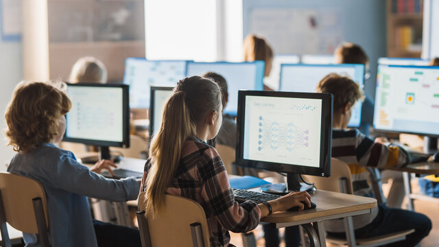 Students ages 7–13 sitting at desks learning together in class